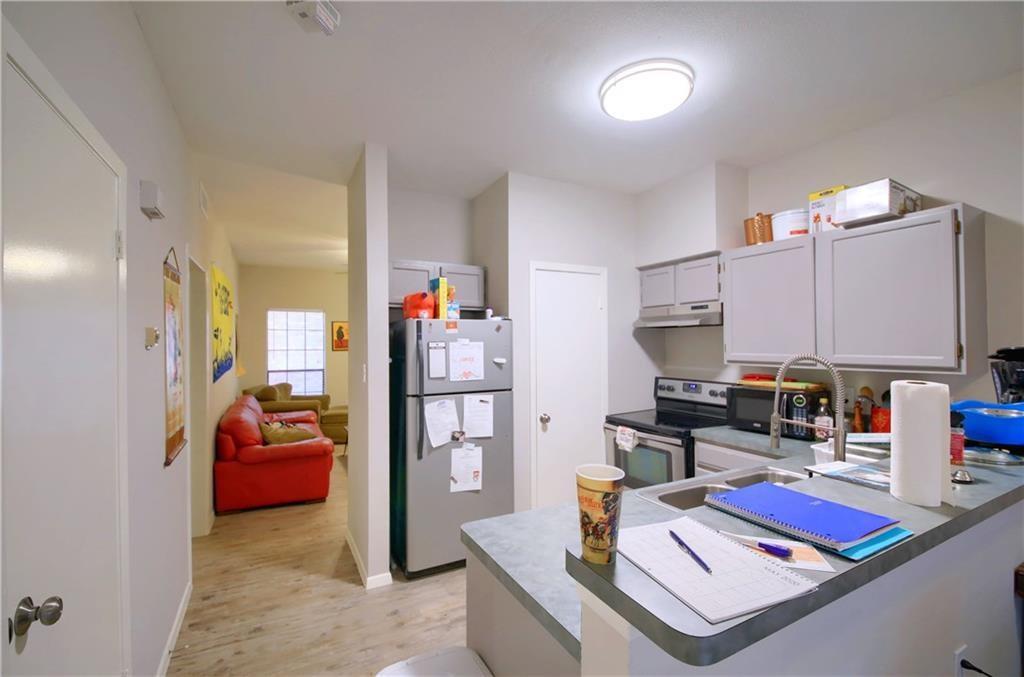 2801 Rio Grande Street, Unit 104 Austin, TX 78705 - Photo 6 of 9 a room with furniture and a book shelf