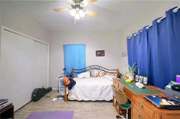a bedroom with bed and a chandelier