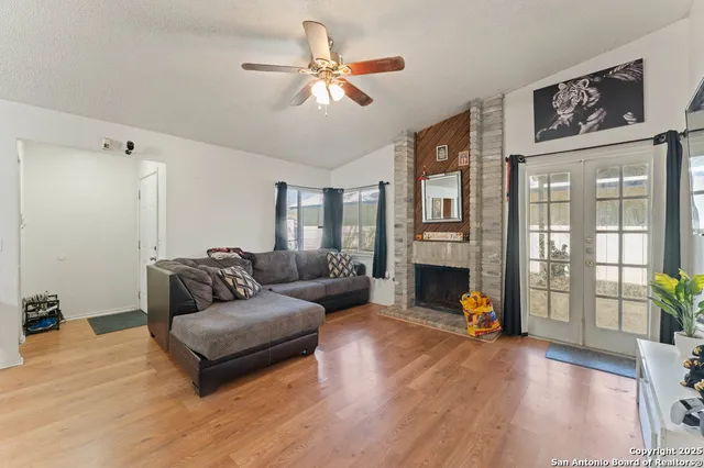 a living room with fireplace furniture and a wooden floor