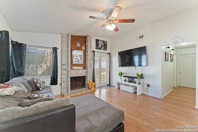 a living room with furniture fireplace and flat screen tv