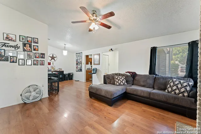 a living room with furniture and wooden floor