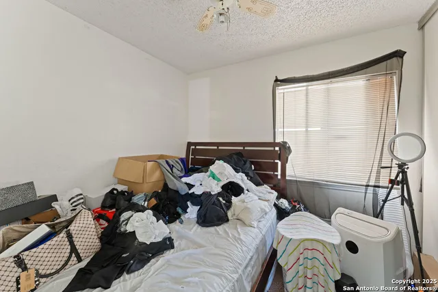 a bed room with a bed and a chandelier