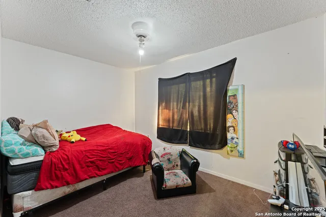 a bedroom with bed and a window