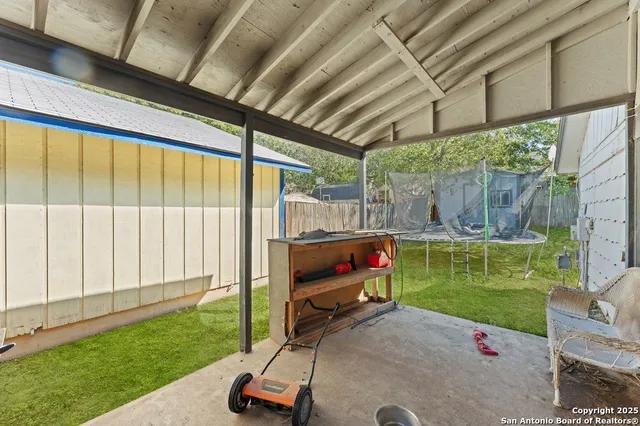 a view of a backyard with a garden and outdoor seating