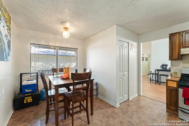 a view of a dining room with furniture and a window