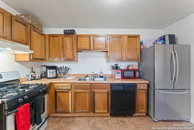 a kitchen with a sink stove and refrigerator