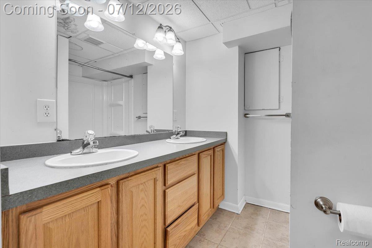 624 North Prospect Road Ypsilanti, MI 48198 - Photo 21 of 28 Double vanity with wood-finish cabinetry, gray countertop, and dual integrated sinks