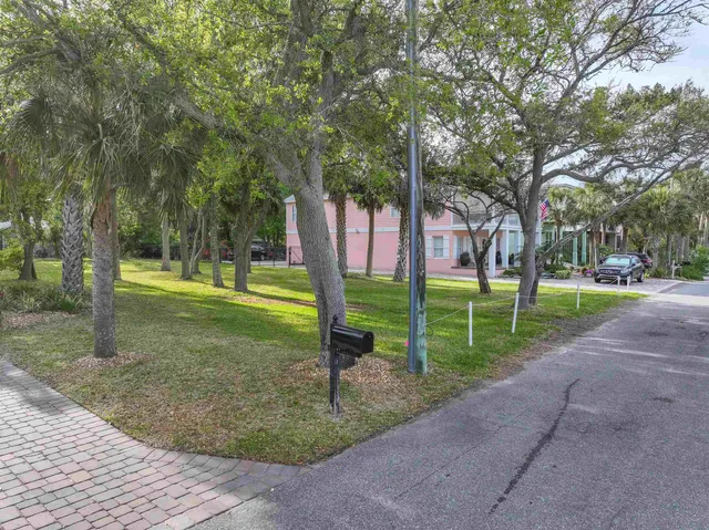 a view of a park with large trees