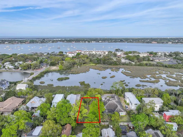 an aerial view of lake and residential houses with outdoor space