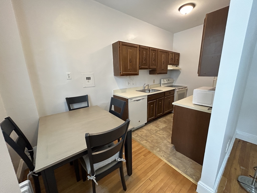 48 Strathmore Road, Unit 4 Boston, MA 02135 - Photo 5 of 10 a view of kitchen with cabinets and wooden floor