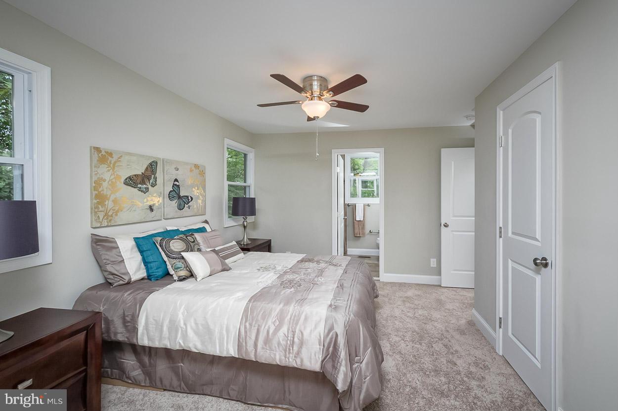 3717 Croydon Road Baltimore, MD 21207 - Photo 14 of 30 a bedroom with a bed and a chandelier