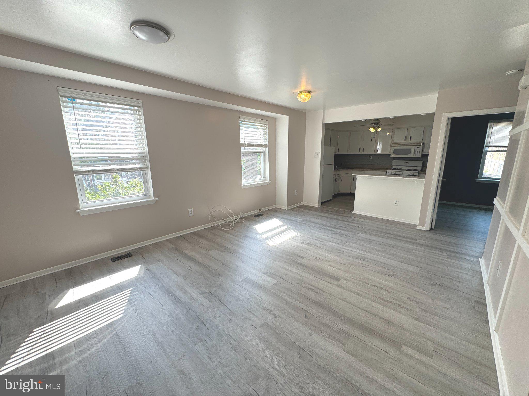 12044 Abby Road, Unit 1 Philadelphia, PA 19154 - Photo 3 of 10 an empty room with wooden floor and windows