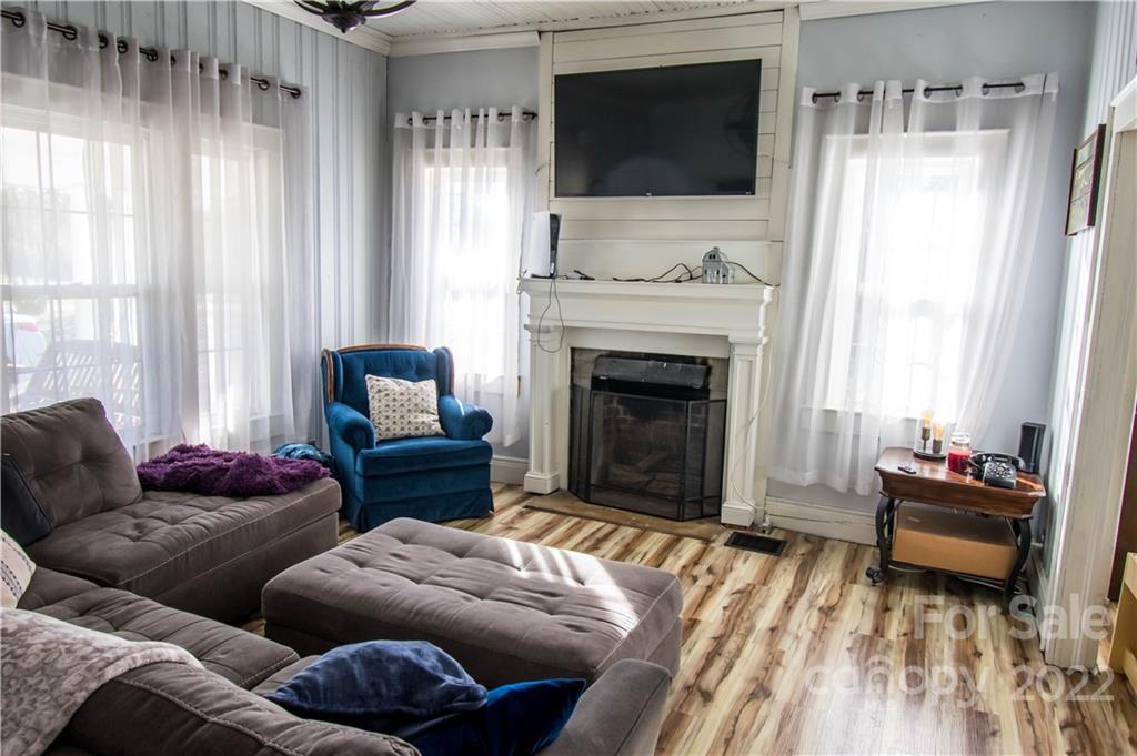 1925 Tryon Courthouse Road Bessemer City, NC 28016 - Photo 5 of 27 a living room with furniture a flat screen tv and a fireplace