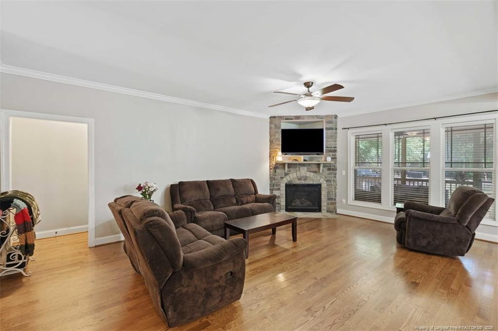 704 Micahs Way North Spring Lake, NC 28390 - Photo 13 of 43 a living room with furniture a fireplace and a flat screen tv