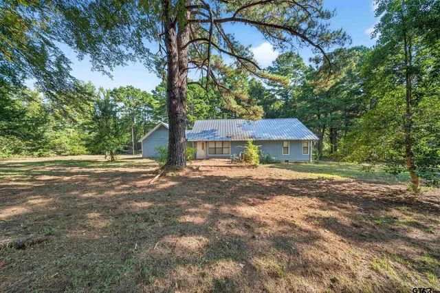 a view of a house with yard and tree s