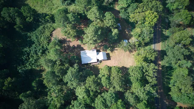 an aerial view of a house with yard