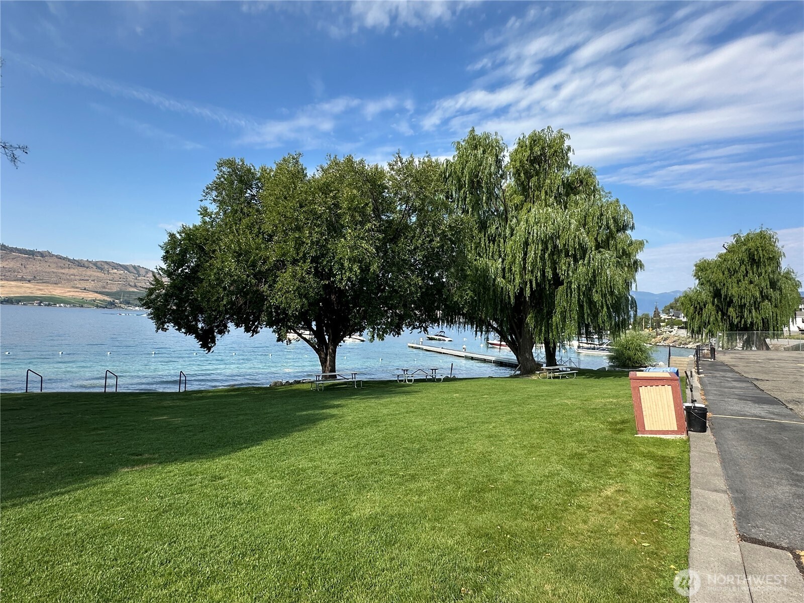 211 Pinnacle Place Chelan, WA 98816 - Photo 12 of 28 a view of a garden with a building in the background