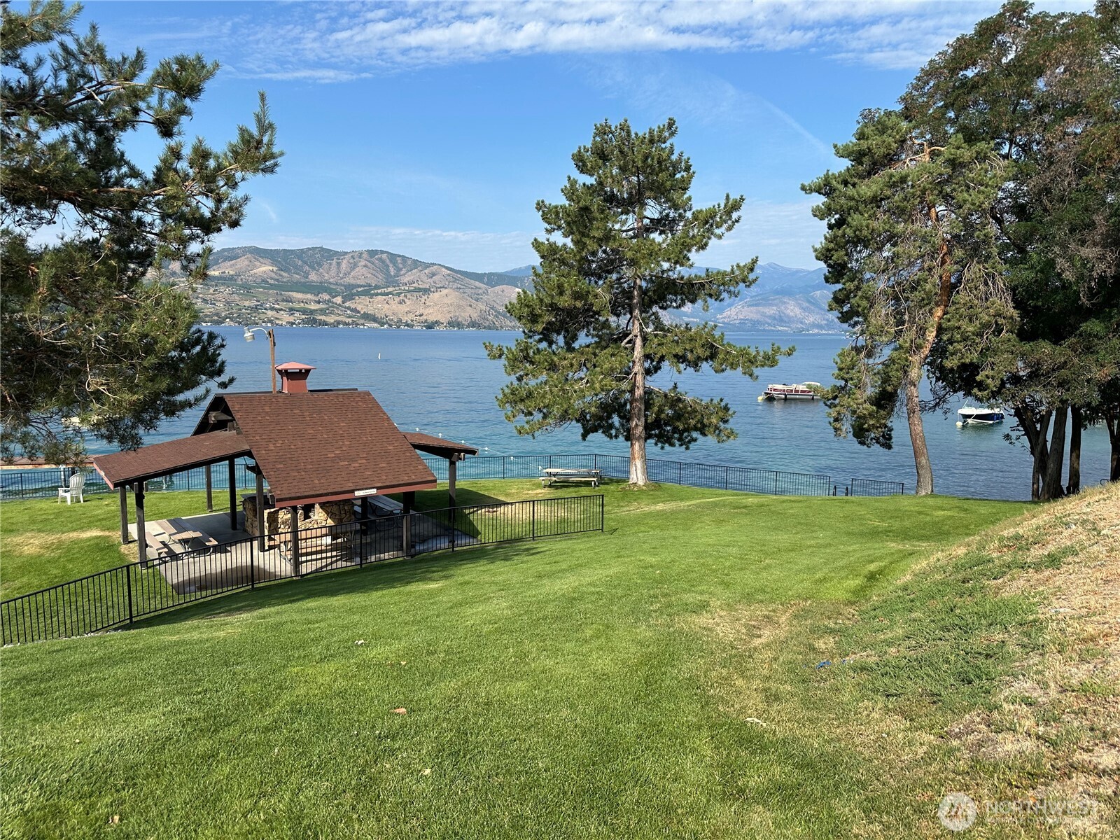211 Pinnacle Place Chelan, WA 98816 - Photo 19 of 28 a view of a house with a yard and sitting area