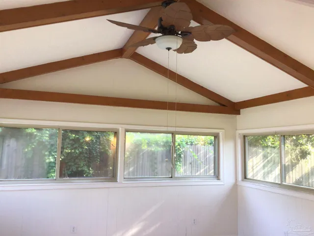 a kitchen with kitchen island granite countertop a sink appliances and cabinets