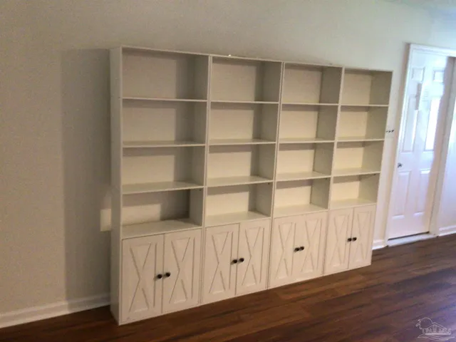 a kitchen with kitchen island granite countertop a sink appliances and cabinets