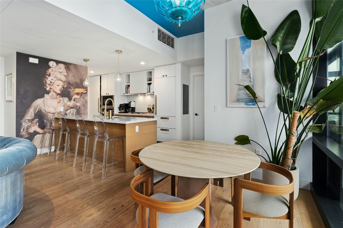 70 Rainey Street, Unit 2702 Austin, TX 78701 - Photo 11 of 40 a view of a dining room with furniture and wooden floor
