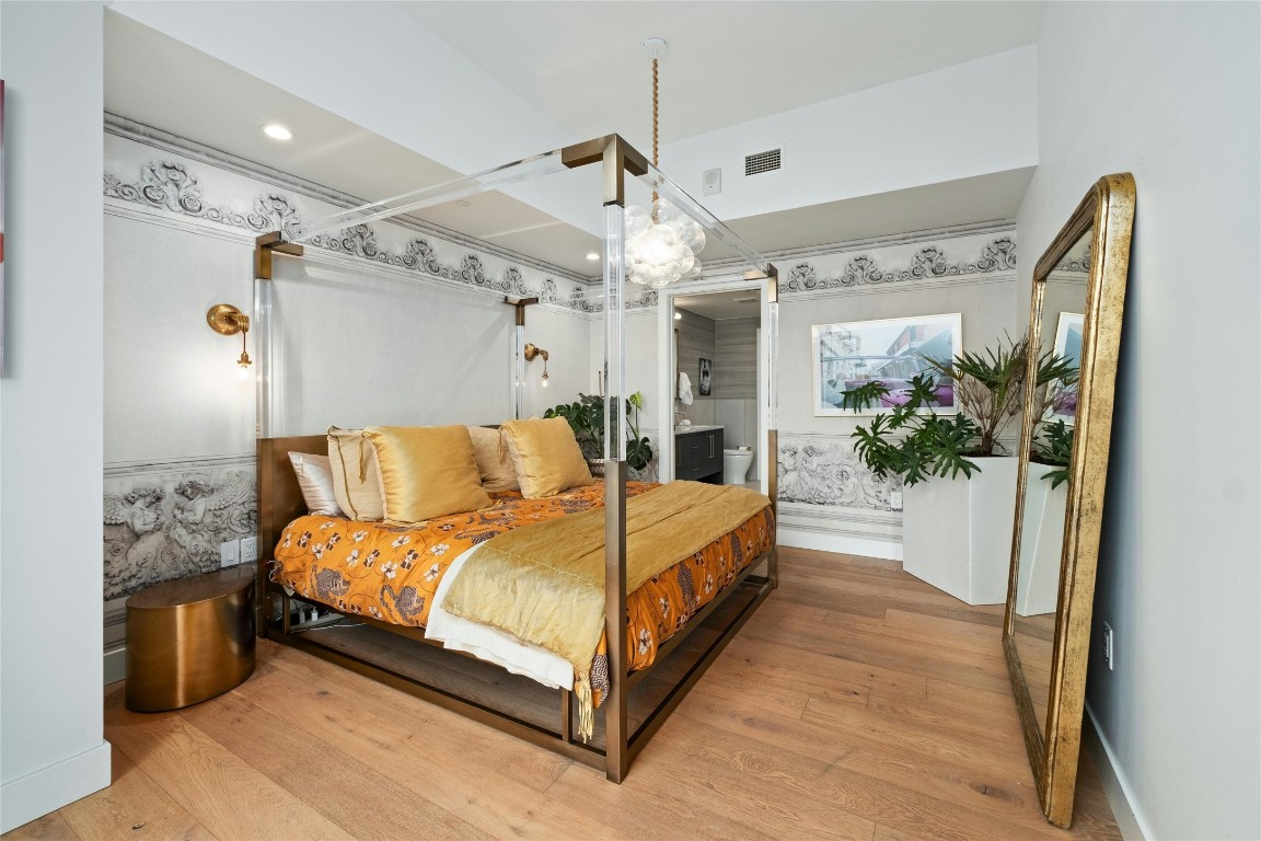 70 Rainey Street, Unit 2702 Austin, TX 78701 - Photo 12 of 40 a bed room with a bed and a potted plant