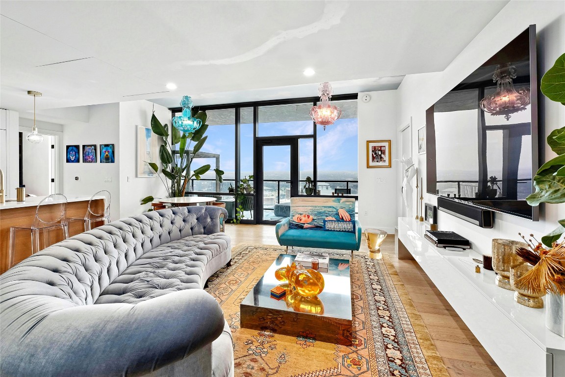 70 Rainey Street, Unit 2702 Austin, TX 78701 - Photo 2 of 40 a living room with furniture fireplace and a potted plant