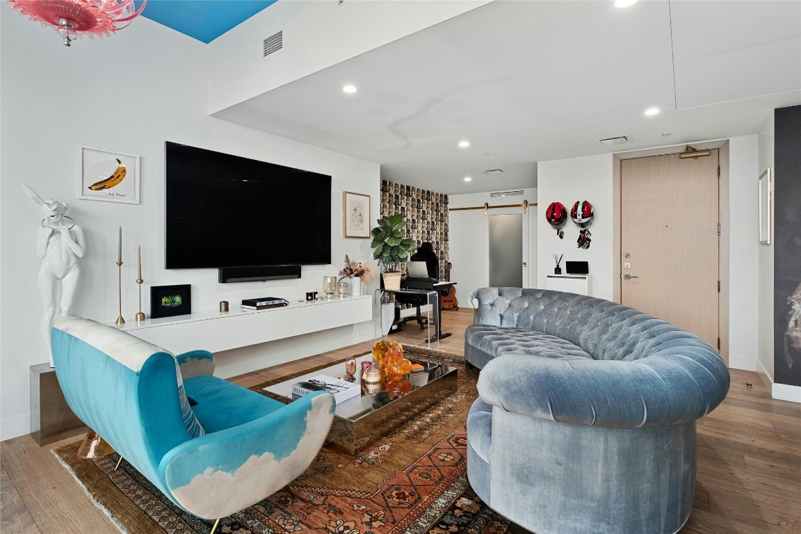 70 Rainey Street, Unit 2702 Austin, TX 78701 - Photo 3 of 40 a living room with furniture and a flat screen tv