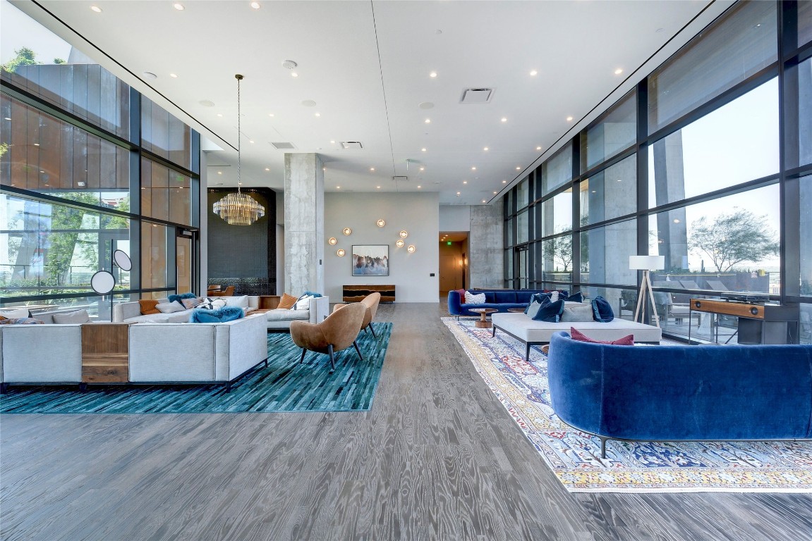 70 Rainey Street, Unit 2702 Austin, TX 78701 - Photo 40 of 40 a living room with couches and kitchen view with wooden floor