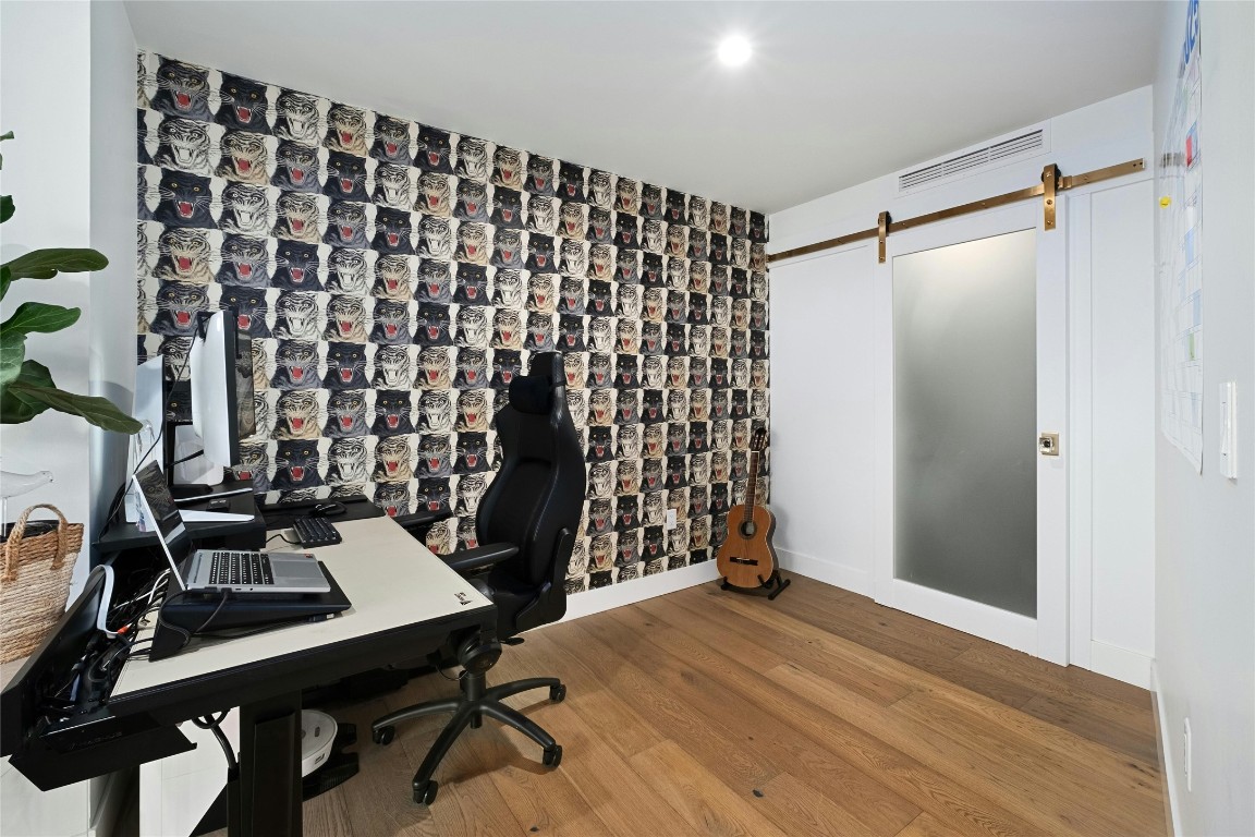 70 Rainey Street, Unit 2702 Austin, TX 78701 - Photo 6 of 40 a view of a workspace with furniture and wooden floor