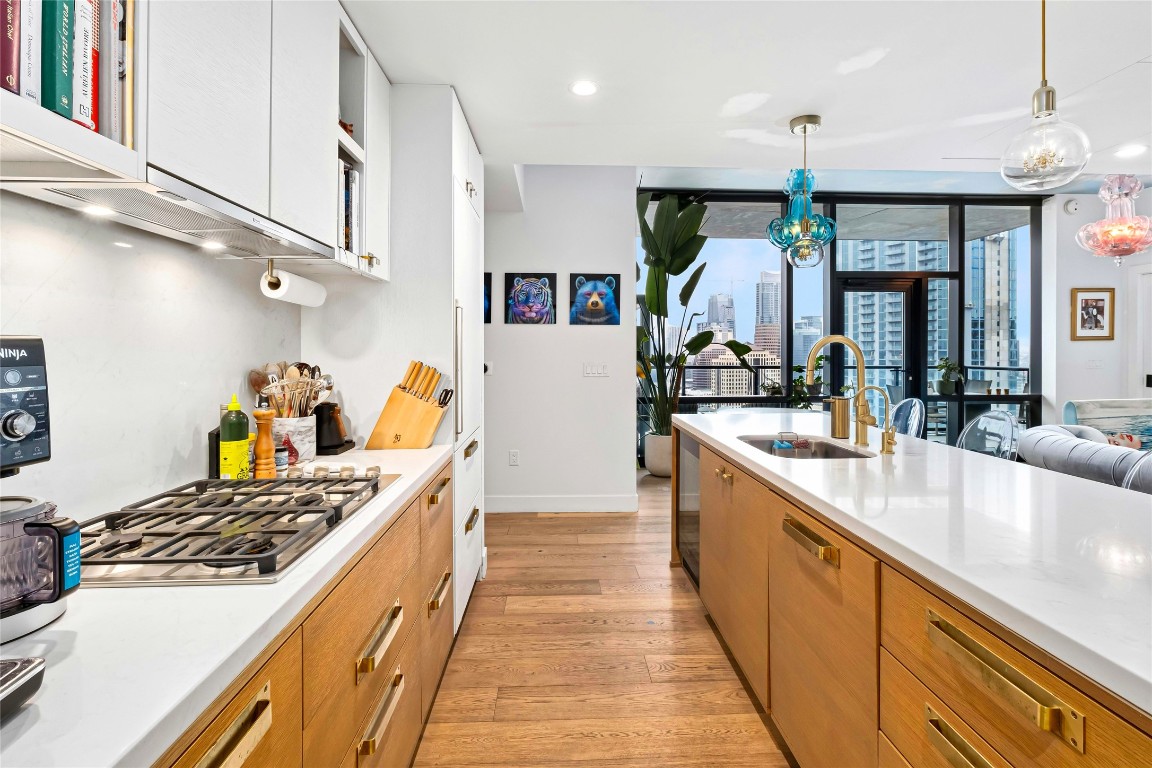 70 Rainey Street, Unit 2702 Austin, TX 78701 - Photo 9 of 40 a kitchen with stainless steel appliances granite countertop a stove and a sink