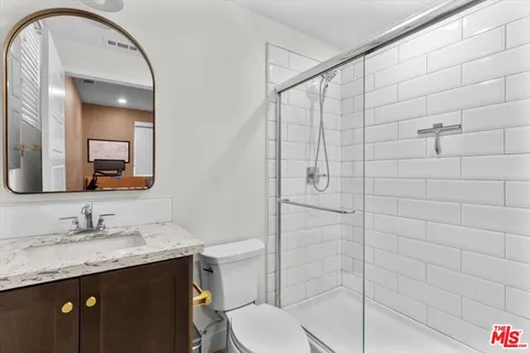 a view of kitchen with refrigerator and stove