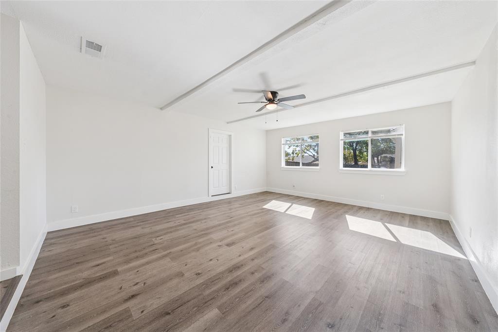 2126 Travis Drive Carrollton, TX 75006 - Photo 12 of 23 wooden floor in an empty room with a window