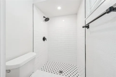 a bathroom with a glass door shower