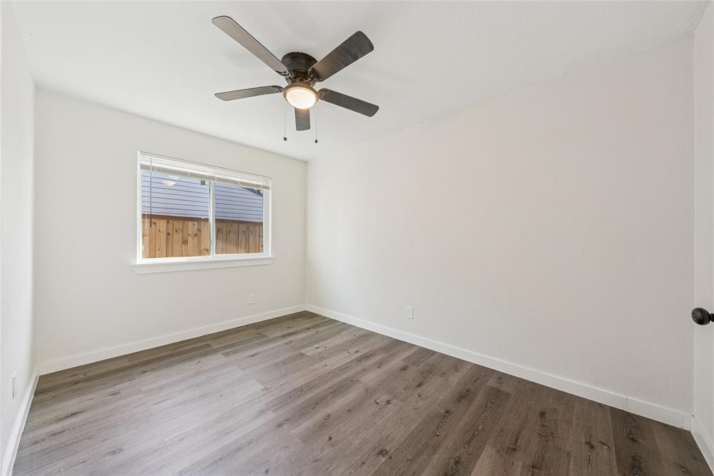 2126 Travis Drive Carrollton, TX 75006 - Photo 19 of 23 an empty room with a window and a fan