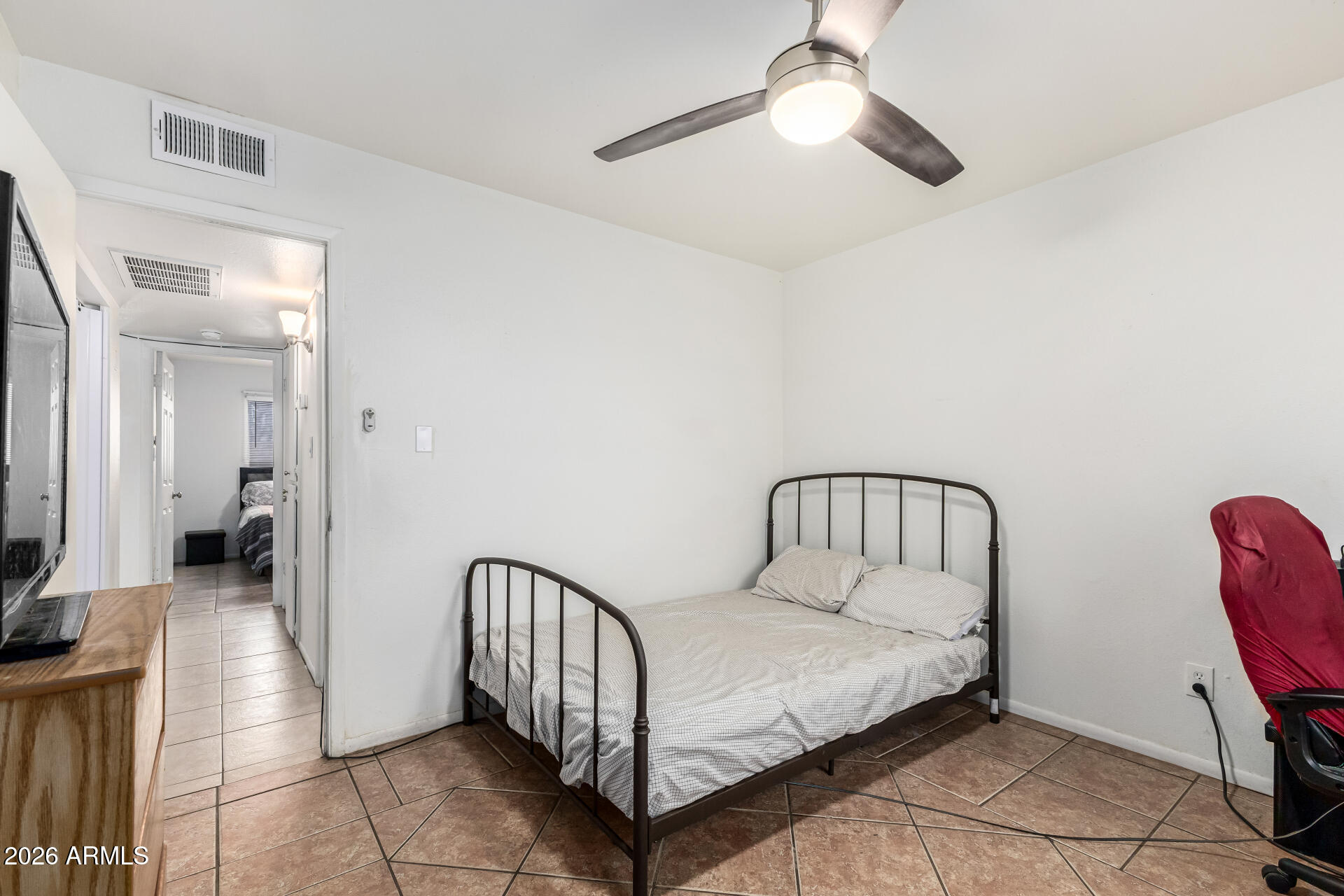600 South Dobson Road, Unit 122 Mesa, AZ 85202 - Photo 23 of 28 a bedroom with a bed and a chandelier