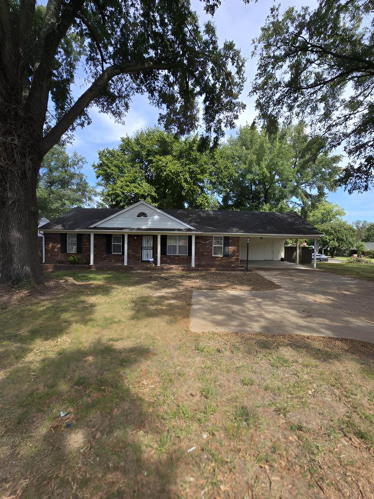 6272 Macon Road Memphis, TN 38134 - Photo 1 of 13 a front view of a house with a garden