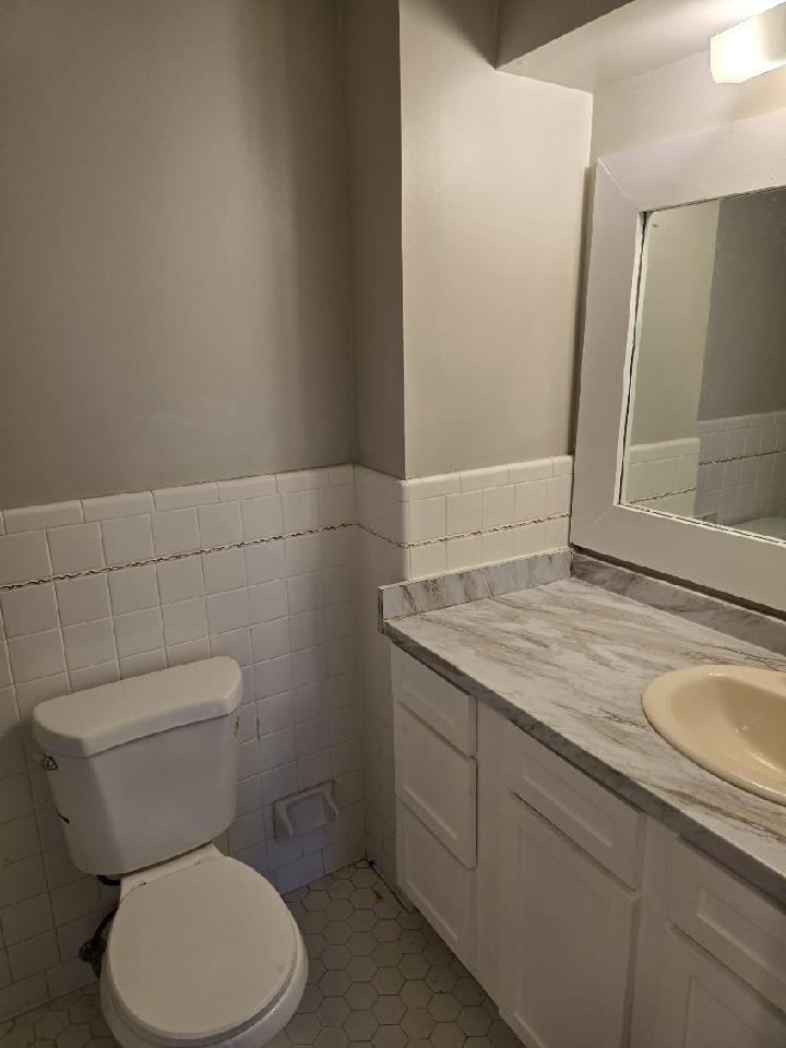 6272 Macon Road Memphis, TN 38134 - Photo 12 of 13 a bathroom with a granite countertop toilet and a sink