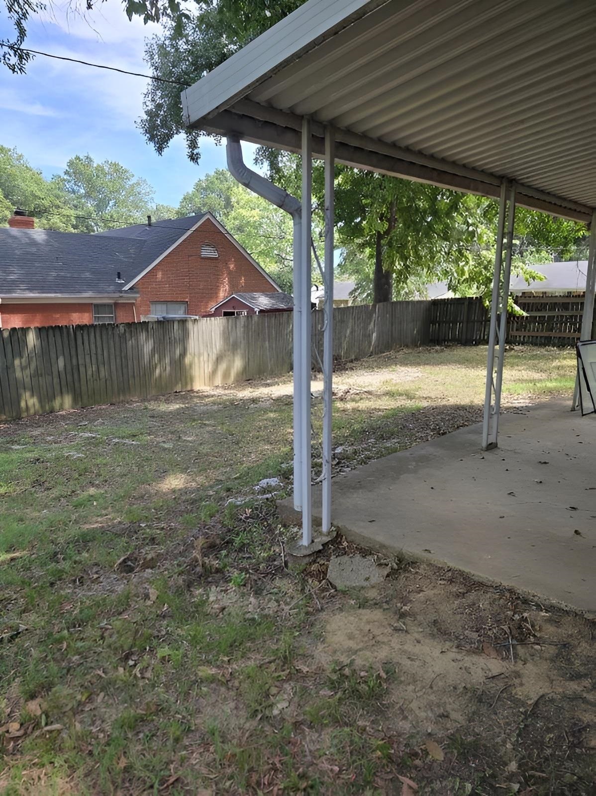 6272 Macon Road Memphis, TN 38134 - Photo 13 of 13 a backyard of a house with a fountain table and chairs