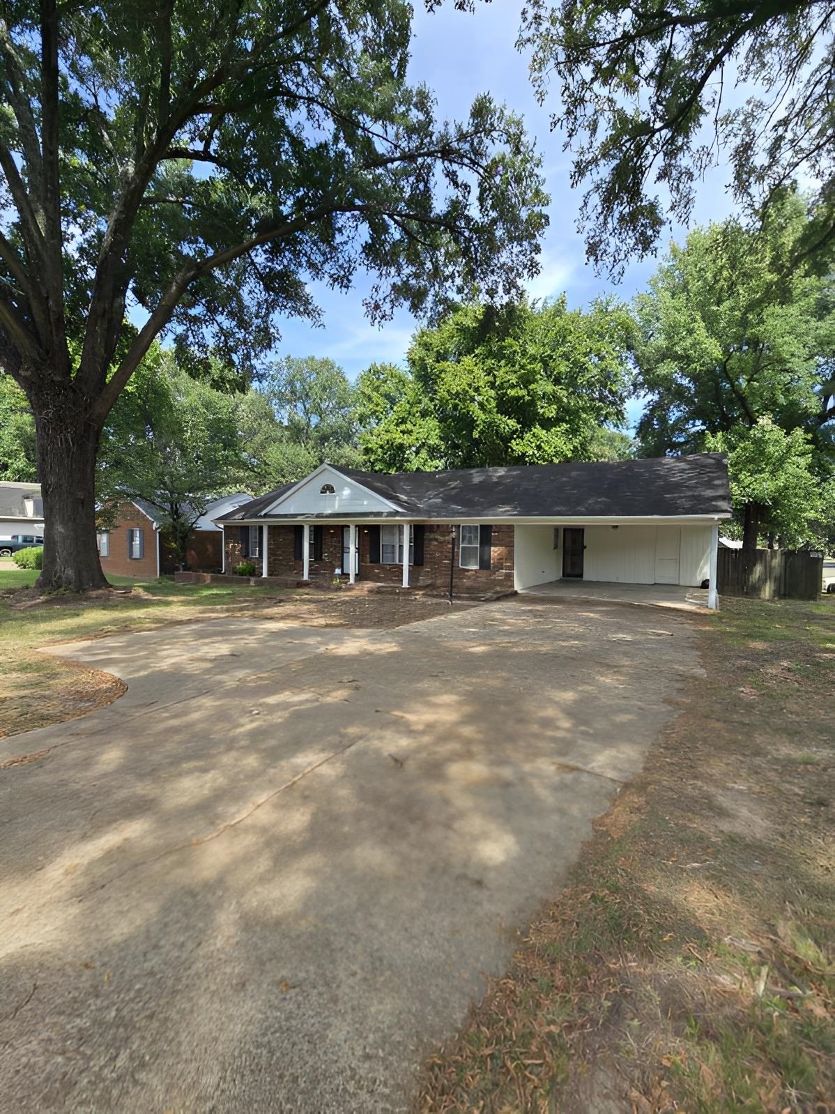 6272 Macon Road Memphis, TN 38134 - Photo 2 of 13 a front view of a house with a garden