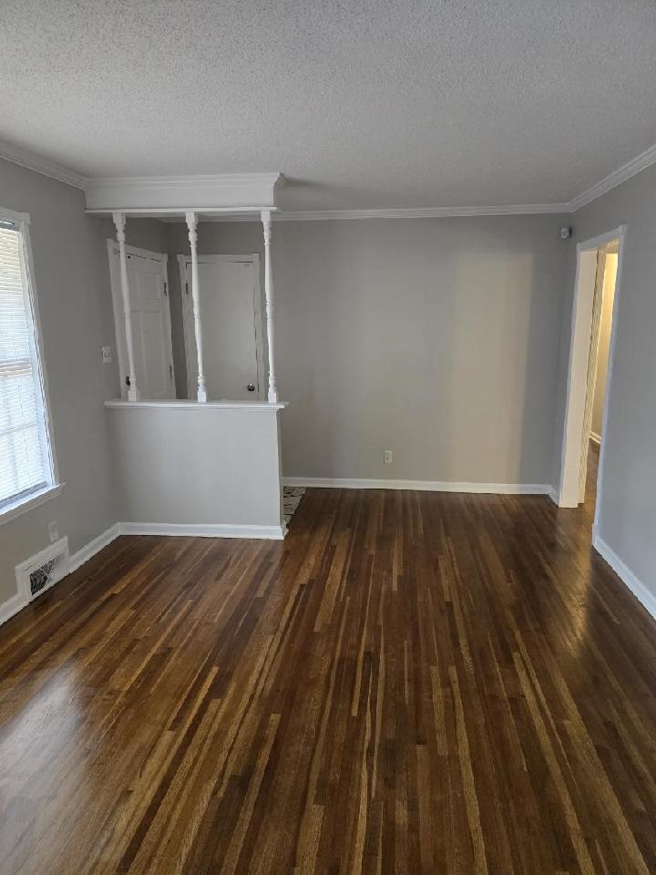 6272 Macon Road Memphis, TN 38134 - Photo 3 of 13 an empty room with wooden floor and windows