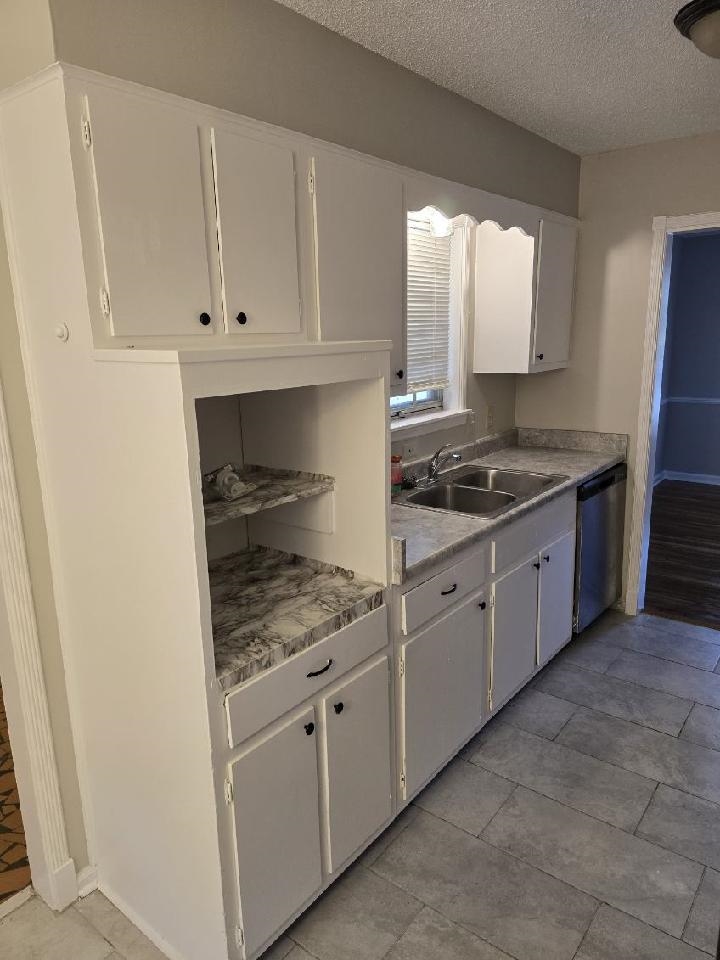 6272 Macon Road Memphis, TN 38134 - Photo 5 of 13 a kitchen with white cabinets and white appliances