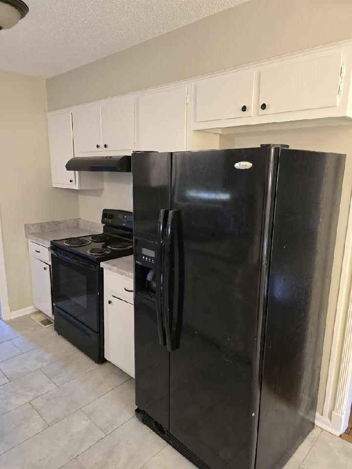 6272 Macon Road Memphis, TN 38134 - Photo 6 of 13 a kitchen with stainless steel appliances granite countertop a refrigerator and a stove