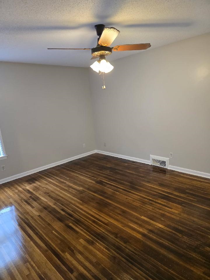 6272 Macon Road Memphis, TN 38134 - Photo 7 of 13 a room with wooden floor fan and window