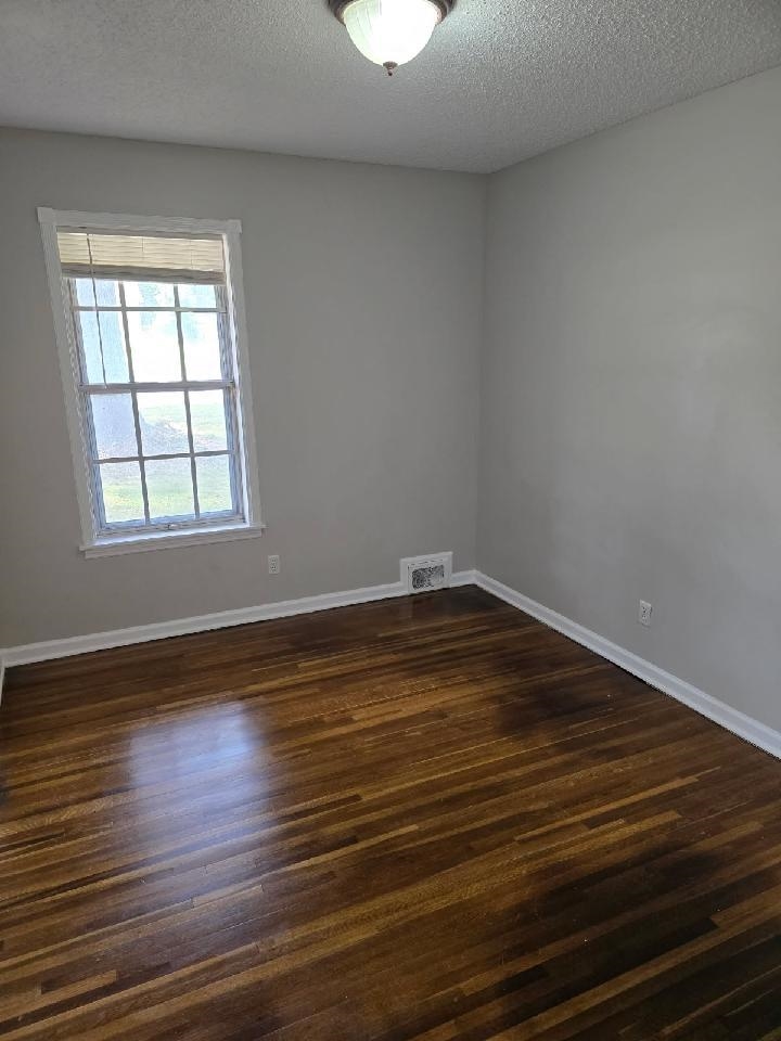 6272 Macon Road Memphis, TN 38134 - Photo 8 of 13 an empty room with wooden floor and windows