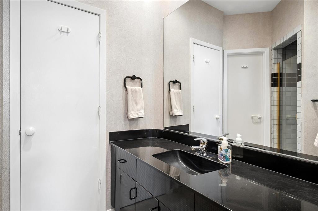 6419 Laurel Valley Road Dallas, TX 75248 - Photo 20 of 34 a bathroom with a granite countertop sink and a mirror
