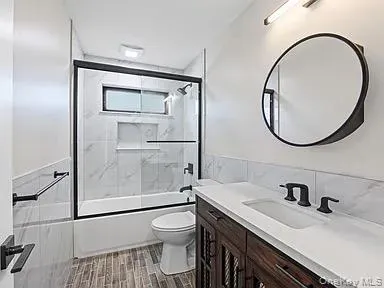 a bathroom with a sink a toilet and a mirror