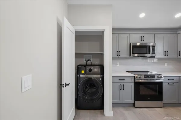a view of a kitchen with a sink a stove and cabinets