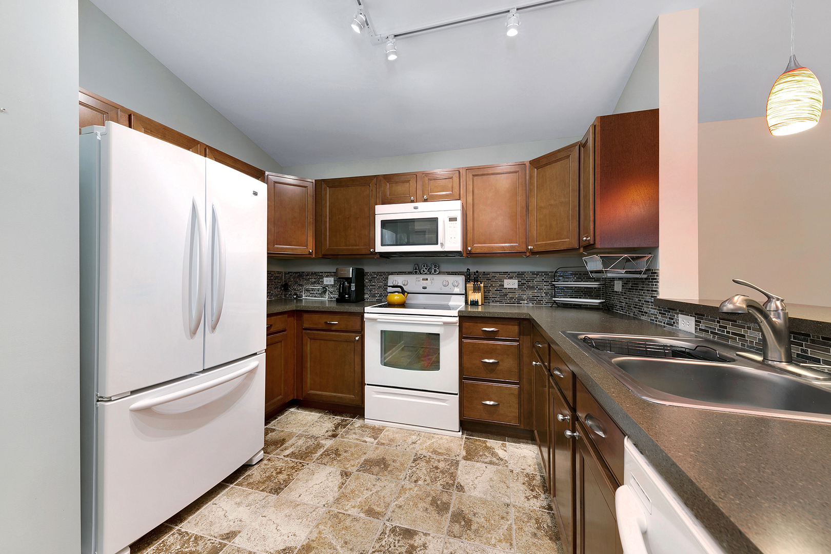 1488 McClure Road, Unit 1488 Aurora, IL 60505 - Photo 5 of 19 a kitchen with granite countertop a refrigerator stove and sink
