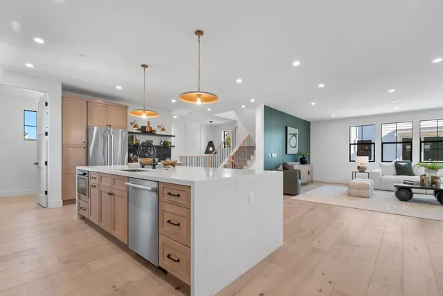 a kitchen with white cabinets and sink